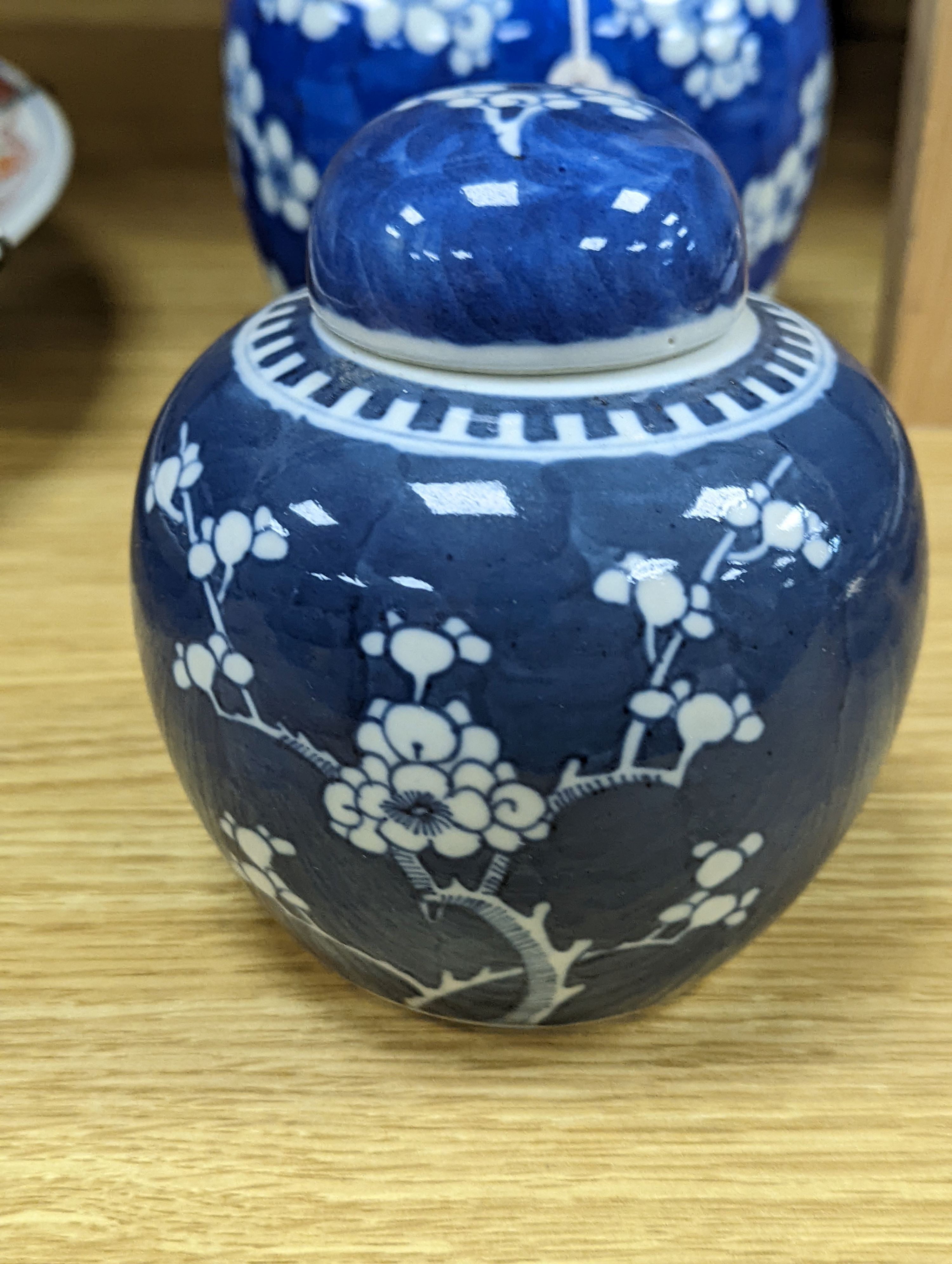 Three Chinese blue and white prunus decorated jars and covers, 19th/20th century, with four character marks 18cm